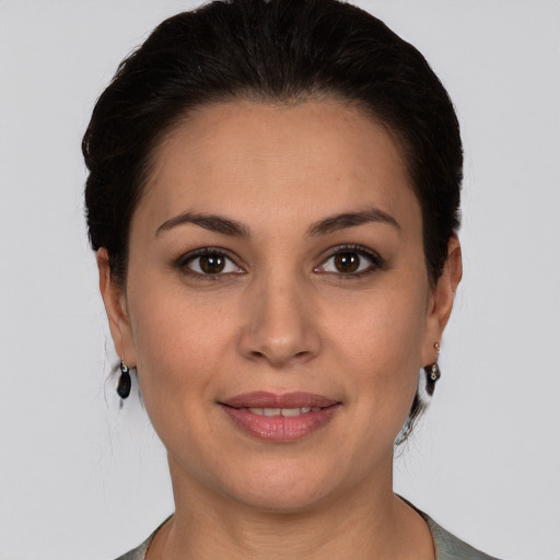 Joyful white young-adult female with medium  brown hair and brown eyes