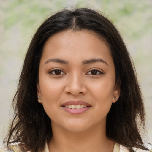 Joyful latino young-adult female with medium  brown hair and brown eyes