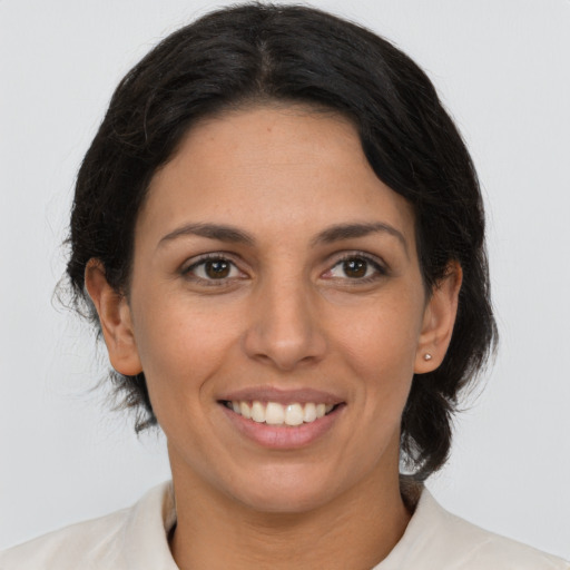 Joyful latino young-adult female with medium  brown hair and brown eyes