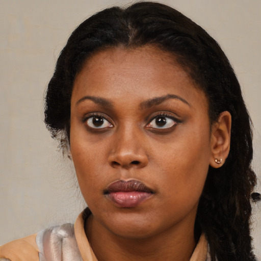 Neutral black young-adult female with medium  brown hair and brown eyes
