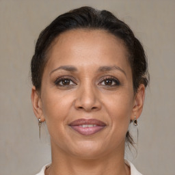 Joyful white adult female with medium  brown hair and brown eyes