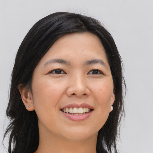 Joyful asian young-adult female with long  black hair and brown eyes