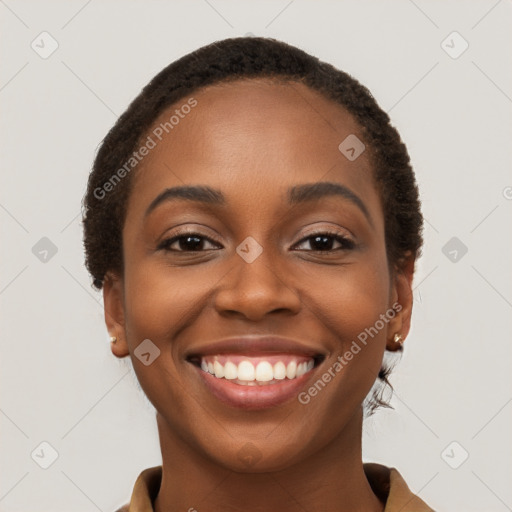 Joyful black young-adult female with short  brown hair and brown eyes