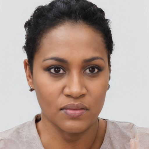 Joyful black young-adult female with short  brown hair and brown eyes