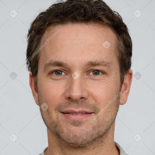 Joyful white adult male with short  brown hair and grey eyes