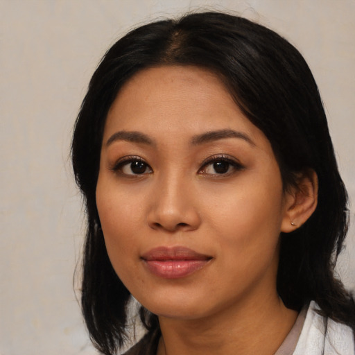 Joyful asian young-adult female with medium  black hair and brown eyes