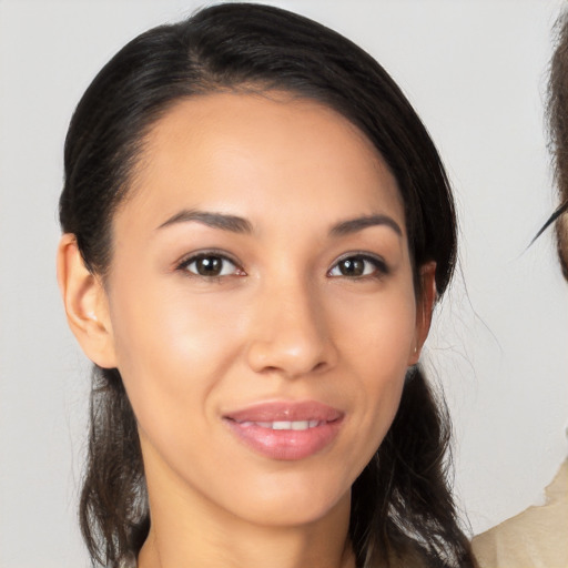 Joyful latino young-adult female with medium  brown hair and brown eyes