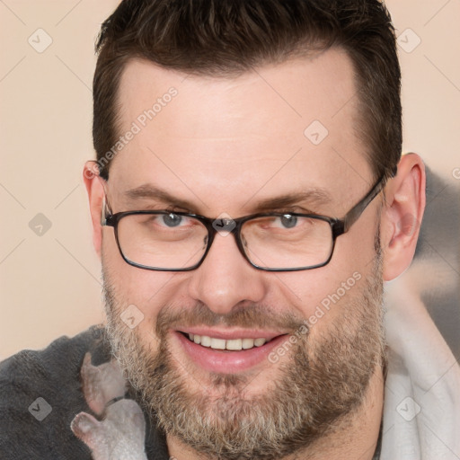 Joyful white adult male with short  brown hair and brown eyes