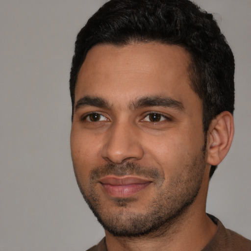 Joyful latino young-adult male with short  black hair and brown eyes
