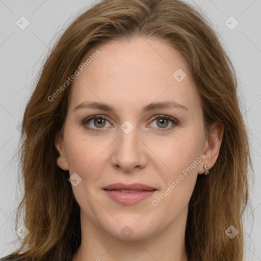 Joyful white adult female with long  brown hair and grey eyes