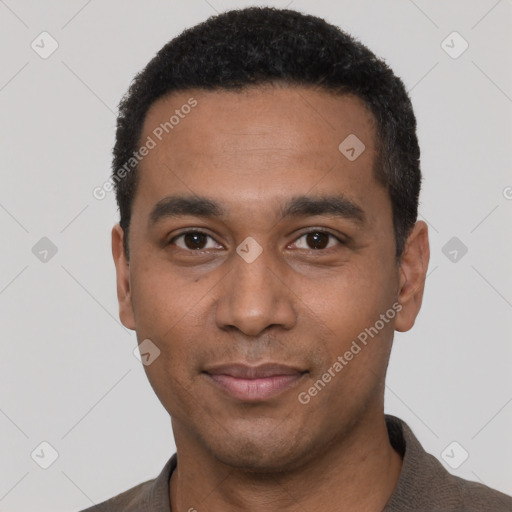 Joyful black young-adult male with short  black hair and brown eyes