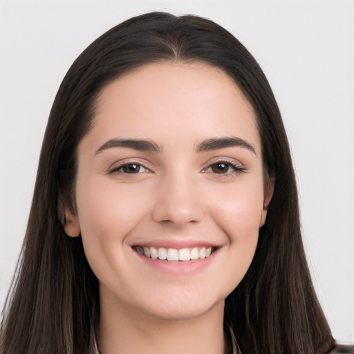 Joyful white young-adult female with long  black hair and brown eyes