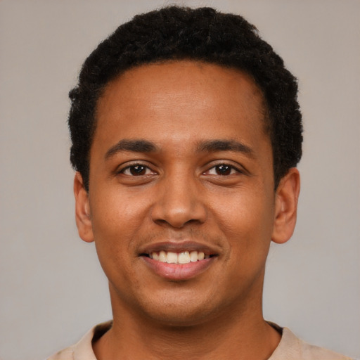 Joyful black young-adult male with short  black hair and brown eyes
