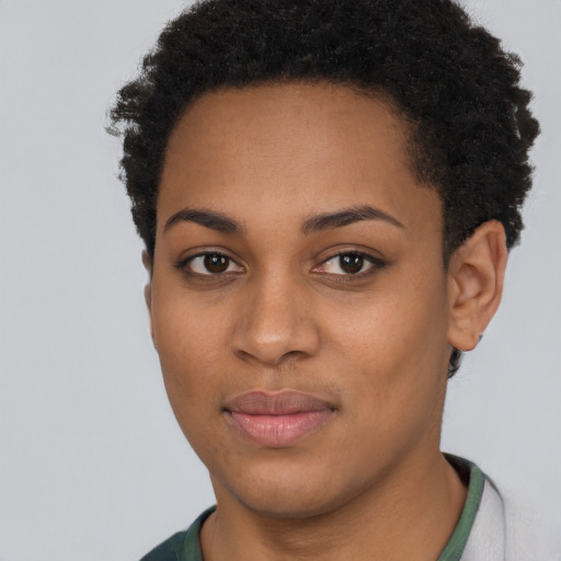 Joyful black young-adult female with short  black hair and brown eyes