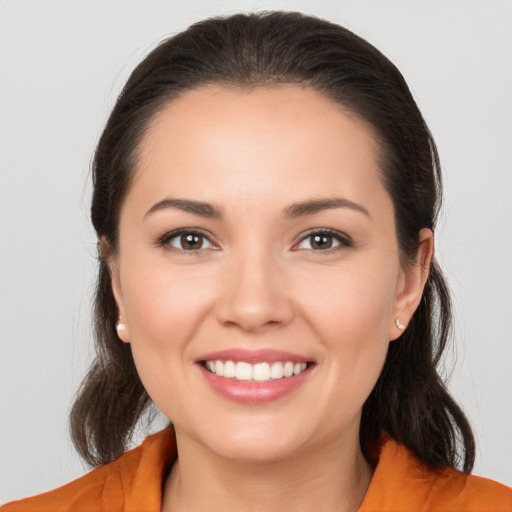 Joyful white young-adult female with medium  brown hair and brown eyes