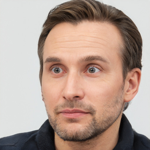 Joyful white adult male with short  brown hair and brown eyes