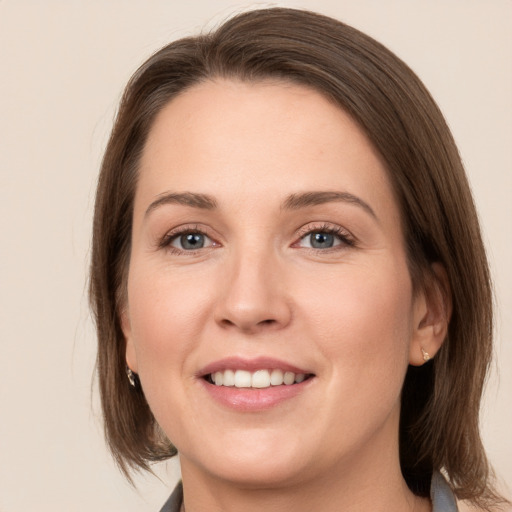 Joyful white young-adult female with medium  brown hair and grey eyes