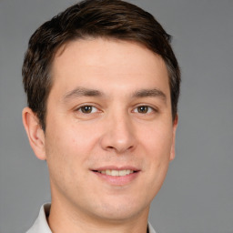 Joyful white young-adult male with short  brown hair and brown eyes