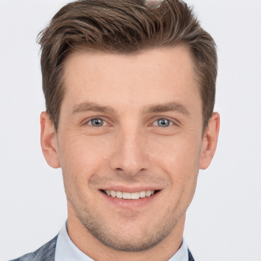 Joyful white young-adult male with short  brown hair and grey eyes