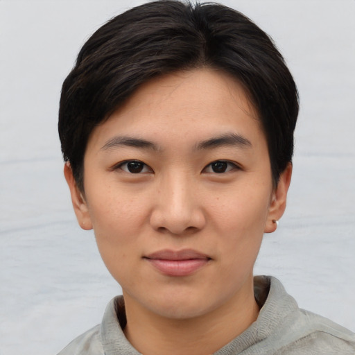 Joyful asian young-adult female with short  brown hair and brown eyes