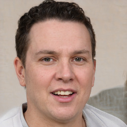 Joyful white adult male with short  brown hair and brown eyes