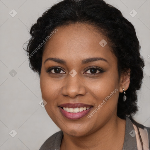 Joyful black young-adult female with long  brown hair and brown eyes