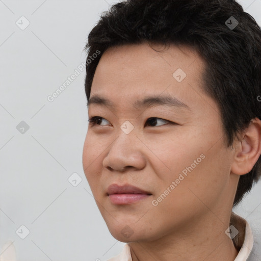 Joyful asian young-adult male with short  black hair and brown eyes