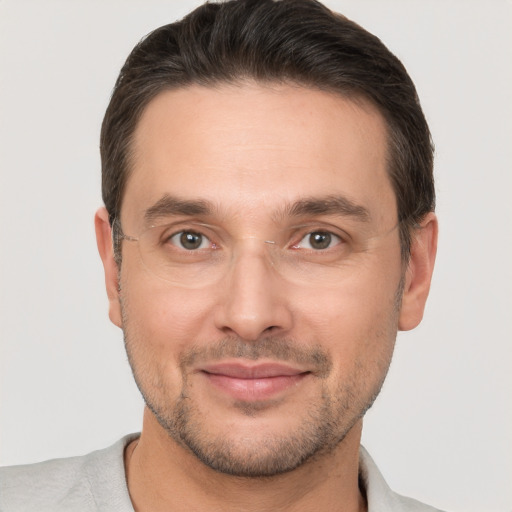 Joyful white adult male with short  brown hair and brown eyes