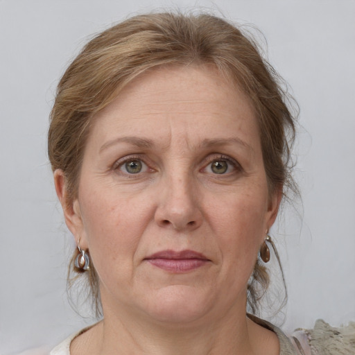 Joyful white adult female with medium  brown hair and grey eyes