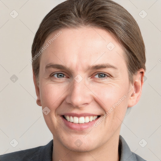 Joyful white adult male with short  brown hair and grey eyes