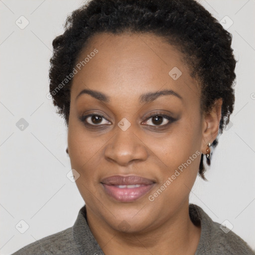 Joyful black adult female with short  brown hair and brown eyes