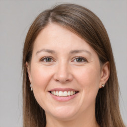 Joyful white young-adult female with long  brown hair and grey eyes