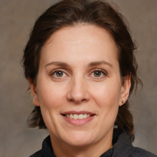 Joyful white adult female with medium  brown hair and brown eyes