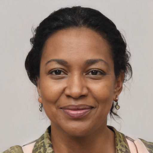 Joyful black adult female with medium  brown hair and brown eyes