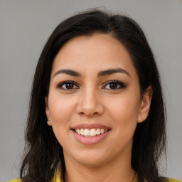 Joyful latino young-adult female with long  brown hair and brown eyes