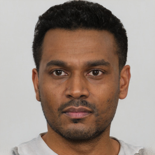 Neutral latino young-adult male with short  black hair and brown eyes
