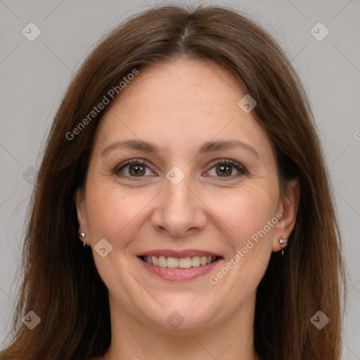 Joyful white adult female with long  brown hair and brown eyes