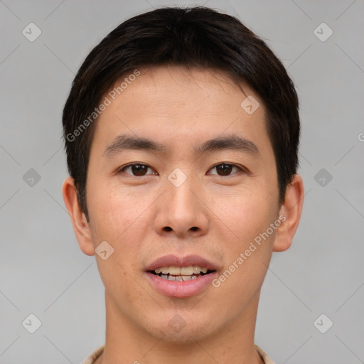 Joyful asian young-adult male with short  brown hair and brown eyes