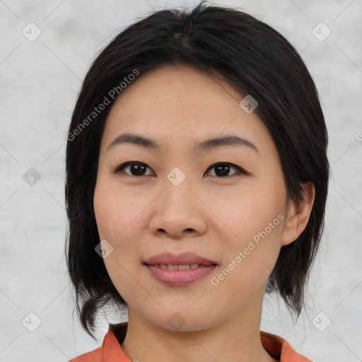 Joyful asian young-adult female with medium  black hair and brown eyes