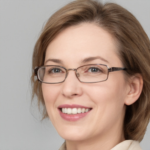 Joyful white adult female with medium  brown hair and blue eyes