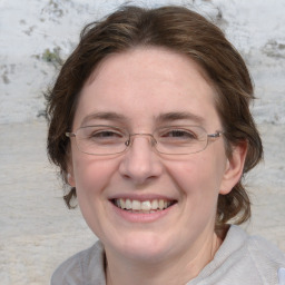 Joyful white adult female with medium  brown hair and blue eyes