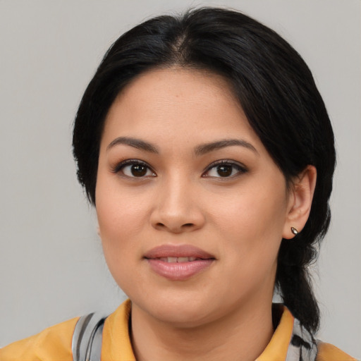 Joyful asian young-adult female with medium  brown hair and brown eyes