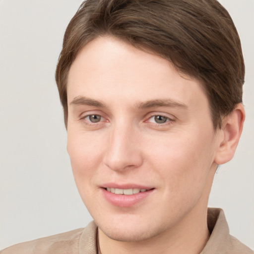 Joyful white young-adult female with short  brown hair and grey eyes