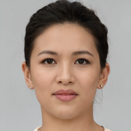 Joyful asian young-adult female with short  brown hair and brown eyes