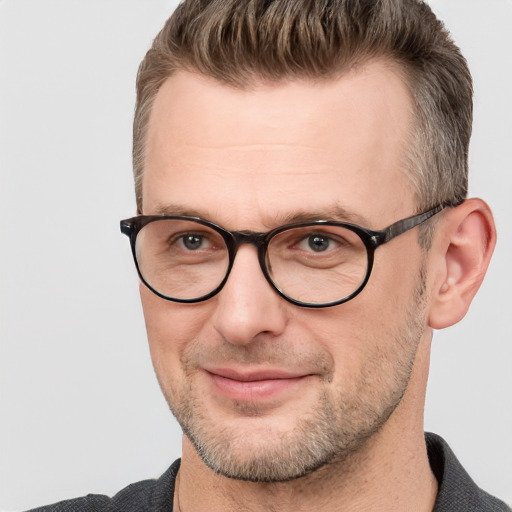 Joyful white adult male with short  brown hair and grey eyes