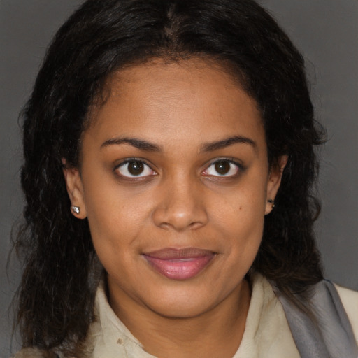 Joyful black young-adult female with medium  brown hair and brown eyes