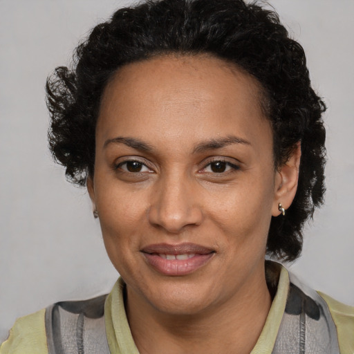 Joyful black adult female with short  brown hair and brown eyes