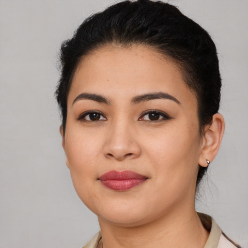 Joyful latino young-adult female with short  brown hair and brown eyes