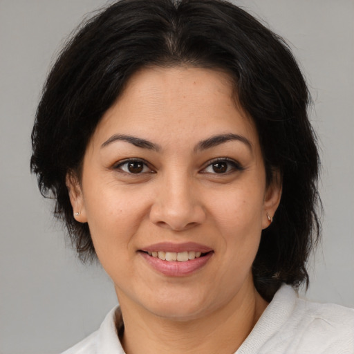 Joyful asian adult female with medium  brown hair and brown eyes