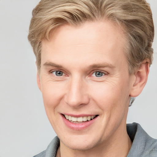 Joyful white adult male with short  brown hair and grey eyes